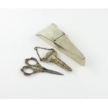 A silver scissor case, marks worn, triangular form, hinged cover, the interior fitted for three