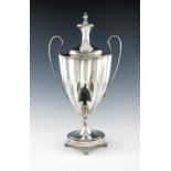 λ A George III old Sheffield plated two-handled tea urn, circa 1790, fluted oval form, loop handles,