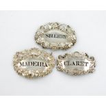 A small collection of three silver wine labels, shaped oval form, one by John Reily, London 1824,