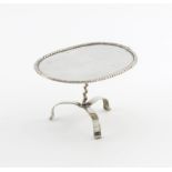 A 19th century Dutch silver tripod table, in the 18th century manner, oval form, swag border, on