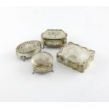 A small collection of four silver dressing table boxes, comprising: one embossed with cherubs, one