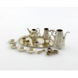 A collection of miniature silver tea wares, comprising: an oval tray with a pierced gallery, three