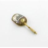 A Russian silver-gilt and niello work caddy spoon, Moscow 1880, maker's mark B.C, shovel form, the