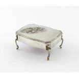 An Edwardian silver trinket box, by H. Matthews, Birmingham 1903, shaped rectangular form, the