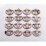 A collection of sixteen enamel wine and toilet labels, cartouche form, with black lettering on a