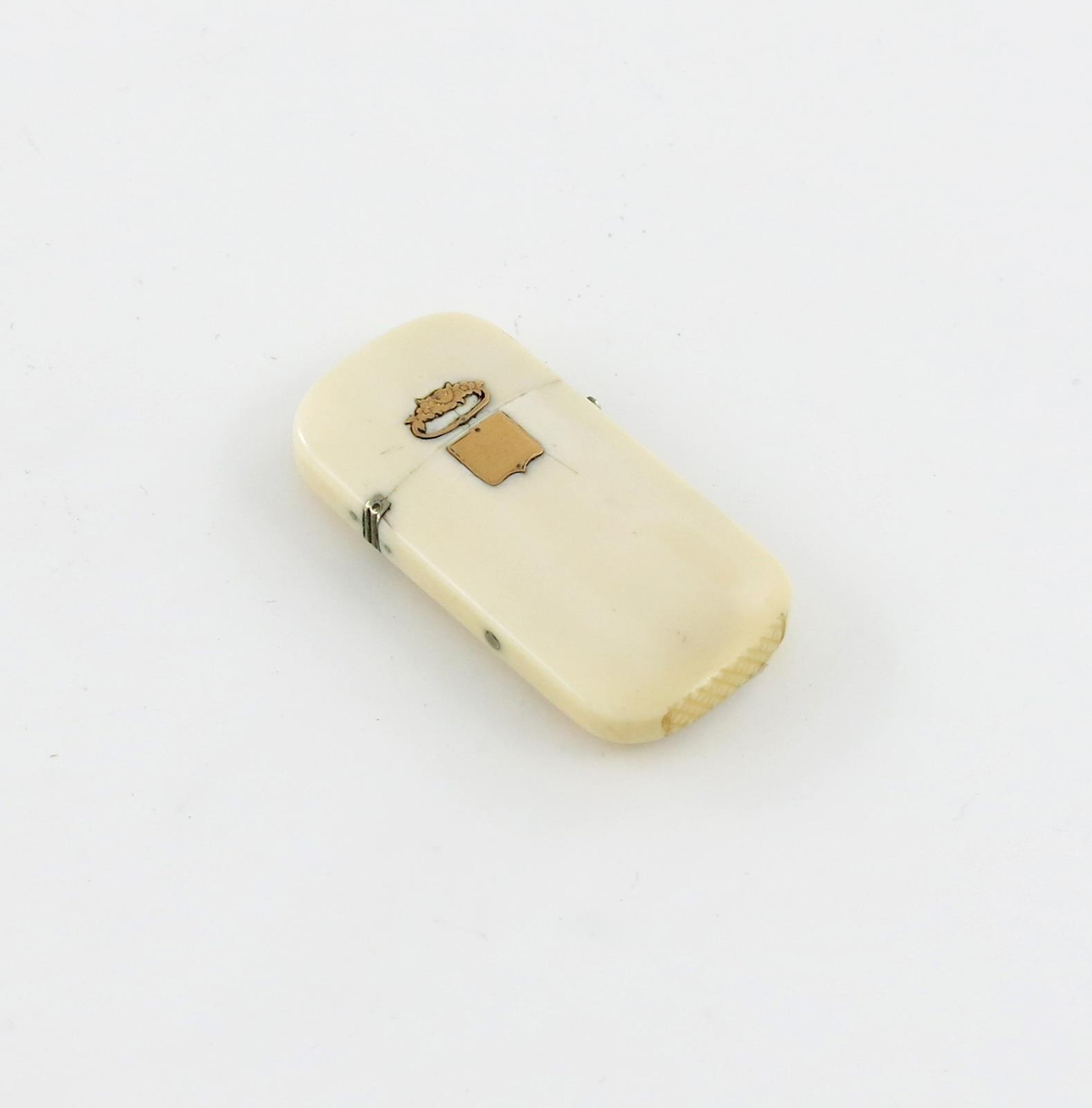 λ A late 19th century ivory vesta case, with a base metal hinge and clasp, applied with a gold