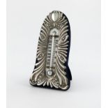 An Edwardian silver thermometer, by William Comyns, London 1902, upright arched rectangular form,