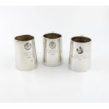 Three regimental silver mugs, by H. Phillips, London 1932 and 1935, tapering circular form, scroll