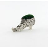 A novelty silver shoe pin cushion, by H. Matthews, Birmingham 1910, embossed foliate scroll