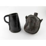 An early 18th century leather tankard, of tapering cylindrical form, scroll handle, plus an 18th