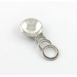 By Charles Boyton, an Art Deco silver caddy spoon, London 1938, also signed Charles Boyton, circular