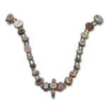 An early 19th century necklace mounted with twenty three assorted carved hardstone intaglios,