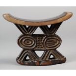 A Shona headrest Zimbabwe wood with carving to the top edges on pierced supports with a central