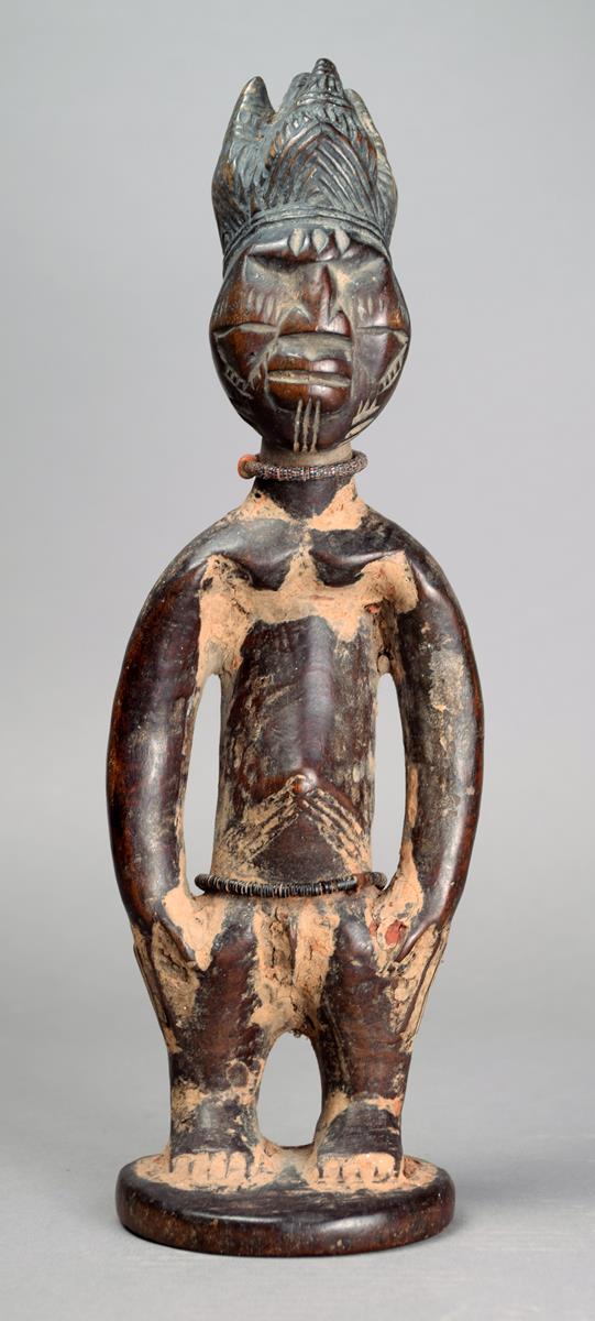 A Yoruba male Ibeji Nigeria wood with a five point coiffure and diamond shape eyes with facial