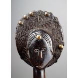 An Ovimbundu staff Angola wood, with a carved head finial with an ovoid coiffure with geometric