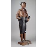 A Madagascan maternity figure wood with brown and black pigment finish, standing with a parted and