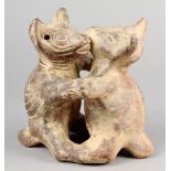 A Colima dancing dogs group Mexico earthenware, standing on their hind legs, with ribbed spines, one