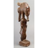 A Baule male figure blolo bian Ivory Coast wood with an ornate coiffure and beard, with facial