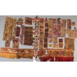 A collection of Pre Columbian textile fragments Peru depicting animals and figures, the largest of a