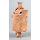 A Colima whistle figure Mexico terracotta, modelled as a warrior holding a shield, with a cut out