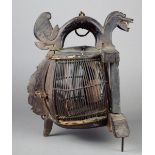 A Lombok bird cage Indonesia wood and bamboo, of demi lune shape with a carved mythical beast