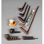 Five Zulu pipes South Africa wood, one with beadwork, 36cm the longest, and three other pipes with