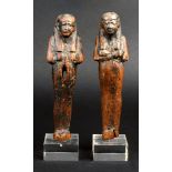 Two Egyptian wood shabtis New Kingdom, circa 1570 - 1070BC with tripartite wigs, facial features and