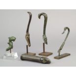 Five Roman bronze handles 1st - 3rd century AD including three of scroll type, one with a lion paw