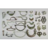 Twenty two bronze fibulae Celtic and Roman the largest, 12.6cm, six bronze buckle clasps, a cross