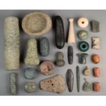 A collection of stone beads, implements and weights including an ovoid mortar and associated pestle,