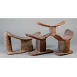 Four Tellem headrests Mali wood; one with a handle and two with end lugs, 26cm the longest. (4)