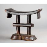 A Tsonga headrest Mozambique wood with a curved top with tapering end lifts on two column supports