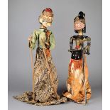 A pair of Javanese puppets Indonesia wood, paint and cloth, 47cm high. (2)