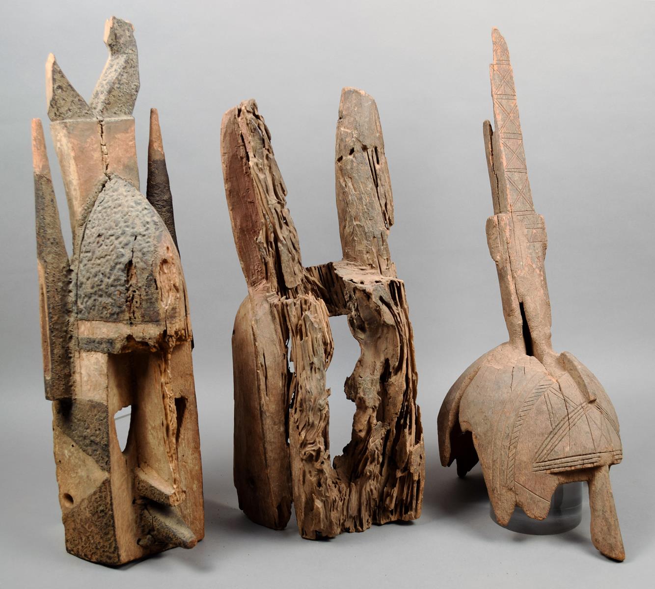 Three Dogon masks Mali fragmentary wood, including a Kanaga mask with black and red pigment, 54.