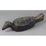 A Borneo mortar Indonesia wood, carved as a bird with a hinged cover revealing a shallow recess,