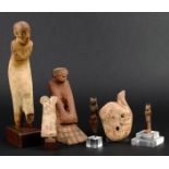 Four Egyptian carved wood figures New Kingdom and later including a male figure leaning forward,