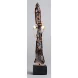 A Geelvinck Bay Korwar amulet New Guinea wood with shell beads, 13.6cm high, on a stand. (2)