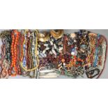 A large collection of loose and strung beads hardstones, metal and glass, including a eleven skulls,