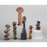 Six miniature figures including a Dogon amulet with an encrusted patina, a Kwere doll, with beads, a