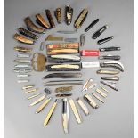λ A collection of penknives including ten with ivory or bone scales, one unusual type with four