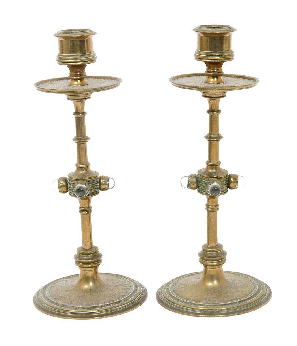 A pair of Gothic Revival brass candlesticks, turned and knopped central column on flaring base,