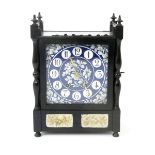 An Aesthetic Movement ebonised wood mantel clock, rectangular form with galleried mantel, set with