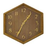 An Art Deco bronze wall clock, hexagonal stepped frame, the wooden dial set with bronze Arabic