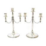 A matched pair of silver three branch candelabra designed by Harold Stabler, by Mappin & Webb and