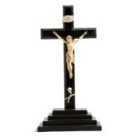 λ A 19th century continental carved ivory Corpus Christi, mounted on an ebonised cross, also with a