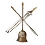 A set of three Victorian steel fire tools, each with a foliate gilt brass handle, with a pierced