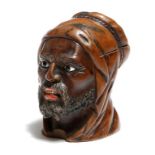 A late 19th century carved wood Moor's head inkwell, with a hinged top and painted lips and bone