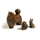 Two Japanese patinated iron models of dogs, of a standing and seated akita together with