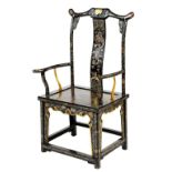 A Chinese black lacquer yoke back armchair, polychrome and gilt decorated with dragons, landscape