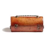 A George III red Morocco leather travelling inkwell, in the form of a trunk with copper handles, the